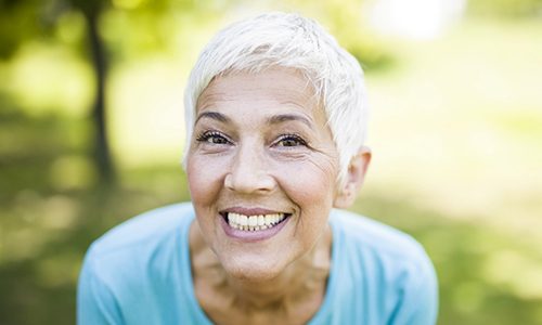 Mature woman showing off her full, beautiful smile