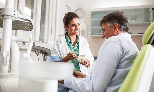Dentist smiling and talking to patient before treatment