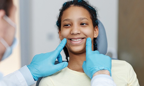 Closeup of patient holding clear aligner