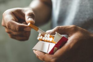 closeup of hands getting out a cigarette